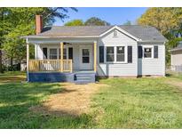 Charming one-story home with a cozy front porch and a well-maintained lawn at 112 Courtland St, Chester, SC 29706