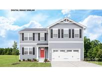 Charming two-story home with gray siding, a red front door, and a well-manicured lawn at 221 Basildon St # 1019, Lancaster, SC 29720