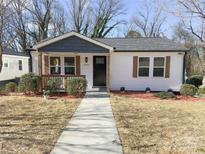 Charming single-story home features white siding, dark gray accents, and a cozy front porch at 226 Malvern Sw Dr, Concord, NC 28025