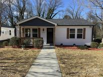 Charming renovated home with new siding, front porch, sidewalk and manicured landscaping at 226 Malvern Sw Dr, Concord, NC 28025