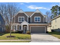 Charming two-story home with gray siding, stone accents, a two-car garage, and a well-maintained lawn at 2352 Seagull Dr, Denver, NC 28037