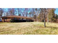 Sprawling brick home with large front yard and mature trees provides great curb appeal at 4937 Lebanon Dr # 1, Charlotte, NC 28273
