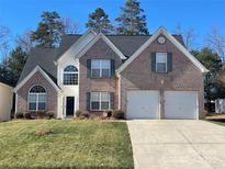 Charming brick two-story home features an attached two-car garage and well-maintained lawn at 5131 Eagle Creek Dr, Charlotte, NC 28269