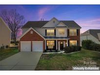 Charming two-story home featuring a brick and siding exterior, two-car garage, and well-manicured lawn at 5841 Lagrande Dr, Charlotte, NC 28269