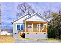 Charming cottage-style home with a cozy front porch and fresh paint at 926 Poplar St, Albemarle, NC 28001