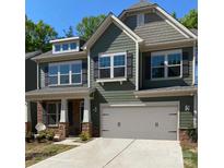 Charming two-story home with a neutral colored garage and stone detail at 1028 Moonlight Mist Rd, Belmont, NC 28012