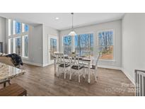 Dining area with large windows and a view of the lake at 13701 Petworth Ct, Charlotte, NC 28278