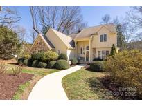 Inviting two-story home featuring stone accents, manicured landscaping, and a welcoming walkway at 16426 Chicora Ct, Norwood, NC 28128