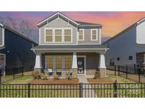 Charming two-story home with a welcoming front porch and manicured landscaping at 500 Cranford Dr # 73, Pineville, NC 28134
