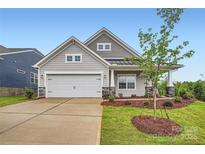 Charming single-Gathering home with a manicured lawn, two-car garage, and welcoming front porch at 8418 Norman Forest Rd, Lancaster, SC 29720