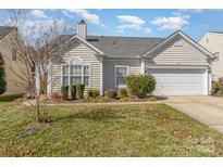 Charming home featuring an attached two-car garage, tidy landscaping, and light siding at 10722 Mountain Springs Dr, Charlotte, NC 28278