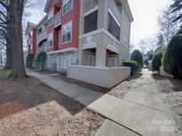 A ground-level exterior view showcasing the side of the building with a walkway at 1162 W 1St St, Charlotte, NC 28202
