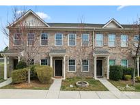 Charming brick townhome with manicured landscaping and welcoming front entrances at 1205 Skywatch Ln, Monroe, NC 28112