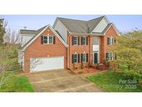 Charming two-story brick home with black shutters, attached two-car garage, and professionally landscaped yard at 1919 46Th Avenue Ne Dr # 46, Hickory, NC 28601