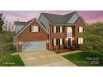 Stunning two-story brick home boasts a well-manicured lawn and attached two-car garage at 1919 46Th Avenue Ne Dr # 46, Hickory, NC 28601