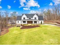 Striking white farmhouse with black trim, beautiful lawn, and manicured landscaping at 2010 Bessbrook Rd, Fort Mill, SC 29708