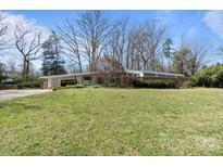 Striking mid-century modern home featuring a low-slung roof and a spacious yard at 2300 Cloister Dr, Charlotte, NC 28211