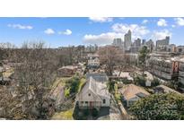 This aerial shows a lovely home with an up-close view of the Charlotte skyline in the background at 416 E 18Th St, Charlotte, NC 28206