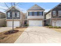 Charming townhome featuring a two-car garage, stone accents, and neutral-colored siding at 1210 Croft Dr # 96, Fort Mill, SC 29708