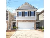 Charming two-story home with stone accents and a spacious two-car garage and a well-kept lawn at 1210 Croft Dr # 96, Fort Mill, SC 29708