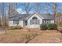 Charming single-story home featuring a well-manicured lawn, gray siding, and a classic roofline at 2913 Ashley Woods Ct, Monroe, NC 28112