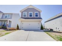 Charming two-story home featuring a wide driveway and a two car garage at 412 Newfound Hollow Dr, Charlotte, NC 28214