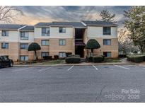 Attractive condo building with well-maintained landscaping and ample parking at 4814 Spring Lake E Dr, Charlotte, NC 28212