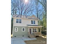 Charming two-story home featuring a cozy front porch, neutral siding, and well-manicured front yard at 613 Granite Ave, Gastonia, NC 28052