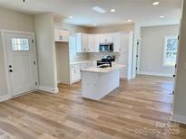 Open kitchen with white cabinetry and stainless steel appliances at 620 Granite Ave, Gastonia, NC 28052