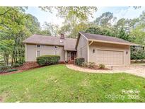 Charming two-story home featuring a well-manicured front lawn and an attached two-car garage at 8082 Golf Course N Dr, Denver, NC 28037