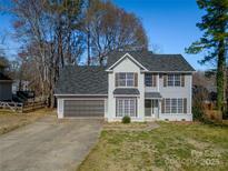 Charming two-story home features a well-maintained yard, attached garage, and neutral color palette at 8220 Poplar Grove Cir, Waxhaw, NC 28173