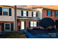 Charming multi-Gathering unit showcasing brick and siding exterior with black shutters, and a well-maintained front yard at 825 21St Ne Ave, Hickory, NC 28601
