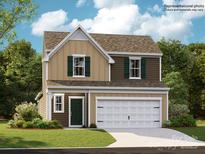 Charming two-story home with a two-car garage, shuttered windows, and a well-maintained lawn at 8421 Norman Forest Rd, Lancaster, SC 29720