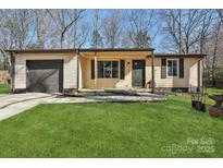 Charming single-story home features a well-manicured lawn and inviting entrance at 8432 Othello Pl, Charlotte, NC 28227