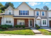 Charming townhouse featuring a well-maintained lawn and brick accents at 110 Rhett Ct, Fort Mill, SC 29715