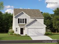 Two-story home features a welcoming facade, attached garage, and well-manicured lawn at 147 Mountain Bridge Way, Statesville, NC 28625