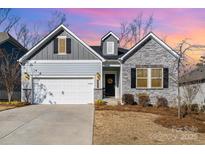 Charming single-Gathering home with a manicured front lawn and two-car garage at 14707 Batteliere Dr, Charlotte, NC 28278