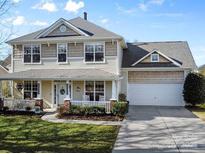 Charming two-story home with a welcoming front porch and manicured lawn, perfect for curb appeal at 2003 Savoy Ct, Indian Trail, NC 28079