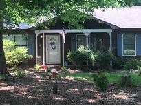 Charming single-story house with a welcoming front porch and well-maintained landscaping at 223 N Lane Rd, Mount Holly, NC 28120