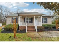 Inviting single-story home featuring a charming front porch and landscaped front yard at 2421 Winfield St, Kannapolis, NC 28083