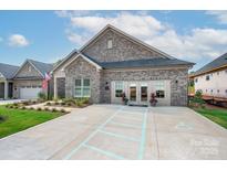 Charming brick home with a well-manicured lawn, accessible parking, and inviting double door entrance at 407 Newstyle Way # 2, Cramerton, NC 28056