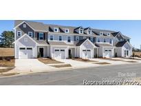 Charming townhome featuring attached garage, and neutral siding creating a welcoming curb appeal at 4170 Claret Cup Dr # 39, Kannapolis, NC 28083
