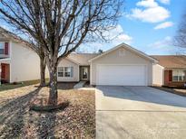 Charming single-Gathering home with a two-car garage, and well-maintained front yard at 4427 Wills Way, Charlotte, NC 28227