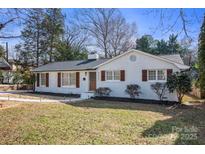 Charming one-story painted brick home with lovely front yard and new walkway at 4913 Seacroft Rd, Charlotte, NC 28210