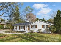 Charming single-story home with a well-manicured lawn, mature trees, and a cozy, inviting entrance at 4913 Seacroft Rd, Charlotte, NC 28210