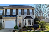 Charming townhome featuring gray siding, black shutters, and a well-maintained front yard at 515 Blue Crush Ct, Rock Hill, SC 29732