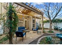 A cozy outdoor patio with a pergola, comfortable seating, and a well-maintained garden at 515 Blue Crush Ct, Rock Hill, SC 29732
