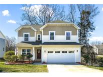 Charming two-story home with well-manicured lawn, attached two-car garage, and beautiful curb appeal at 734 Rocky Grove Gln, York, SC 29745