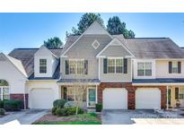 Charming townhome with a gray exterior, well-manicured landscaping, and attached one car garage at 8929 Bryant Field Cir, Charlotte, NC 28277
