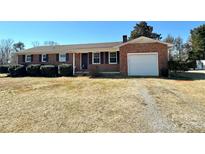 Charming brick ranch-style home with a one-car garage and a well-maintained front yard with mature landscaping at 95 Icard Ridge Road Ext, Granite Falls, NC 28630